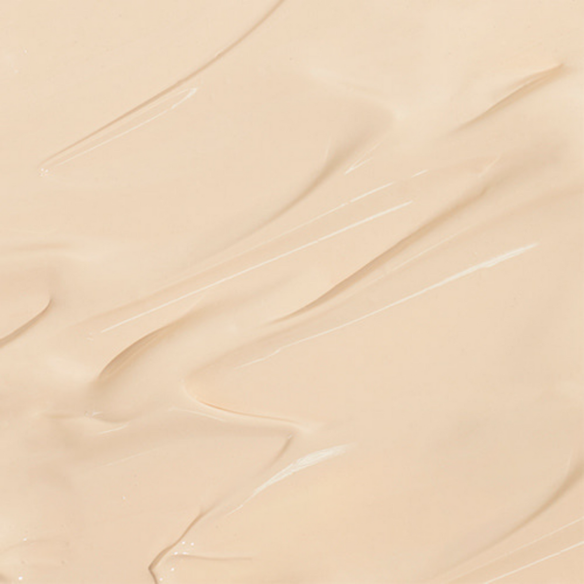 Texture de crème teintée beige étalée en bandes