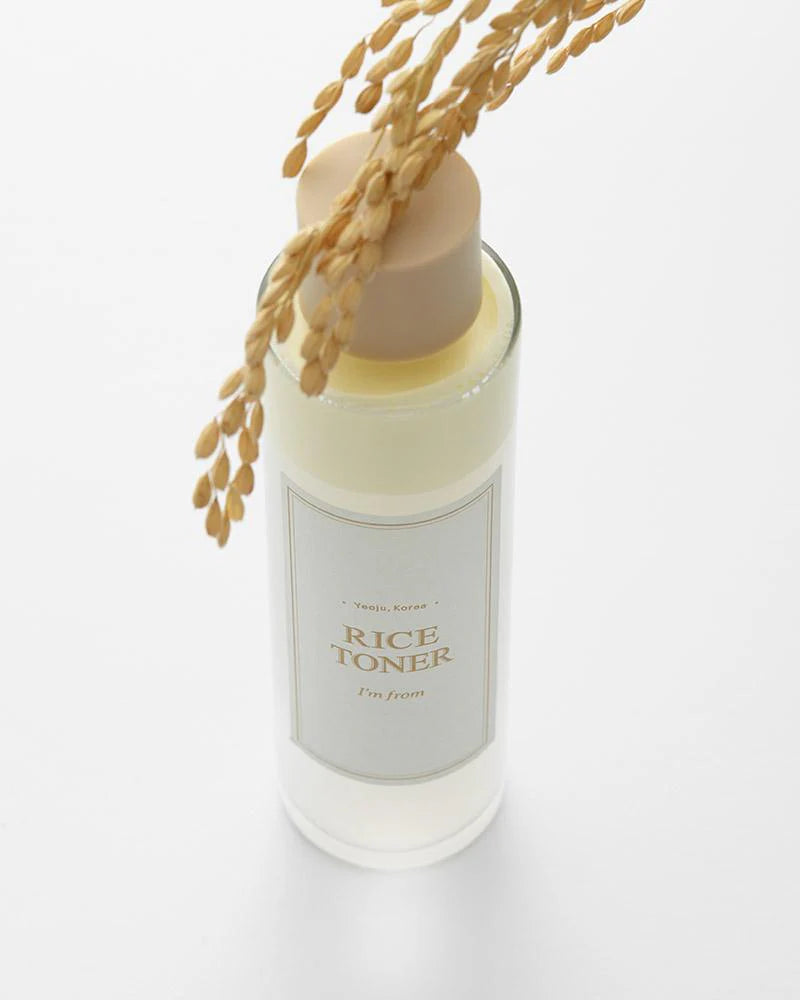 Flacon de lotion au riz sous un épi doré