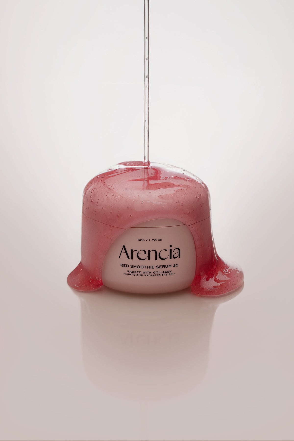 Gel rose filant coulant sur un pot de sérum