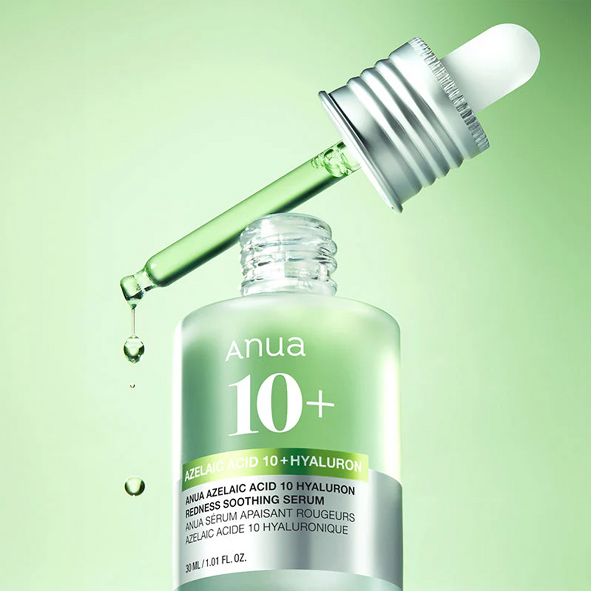 Pipette de sérum vert laissant tomber une goutte près du flacon