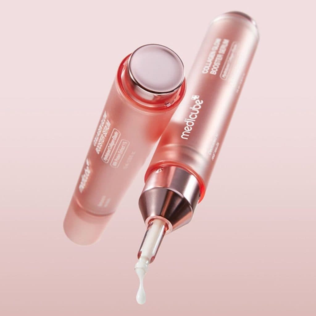 Applicateurs roses de sérum avec une goutte blanche à l&