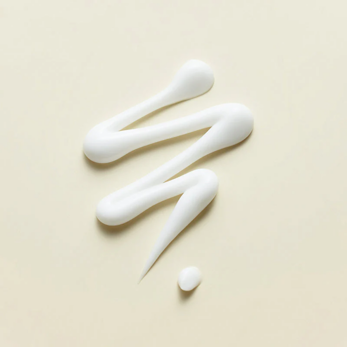 Ruban de crème blanche en zigzag sur fond beige