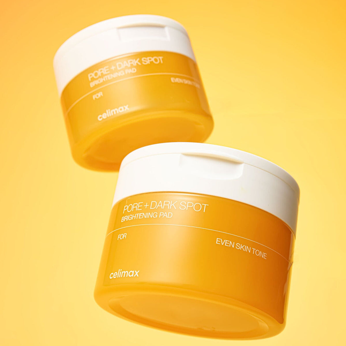 Deux pots orange de disques à couvercles blancs