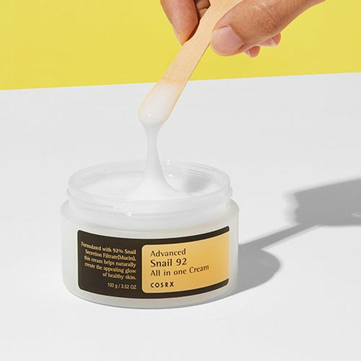 Crème blanche filante prélevée à la spatule dans le pot