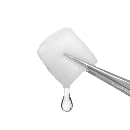 Coton imbibé de soin transparent tenu à la pince