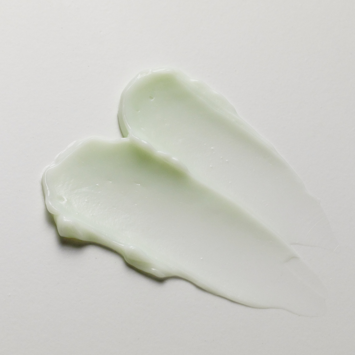 Texture de crème vert pâle en deux traces superposées