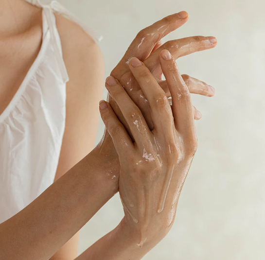 Huile nettoyante étalée entre les mains