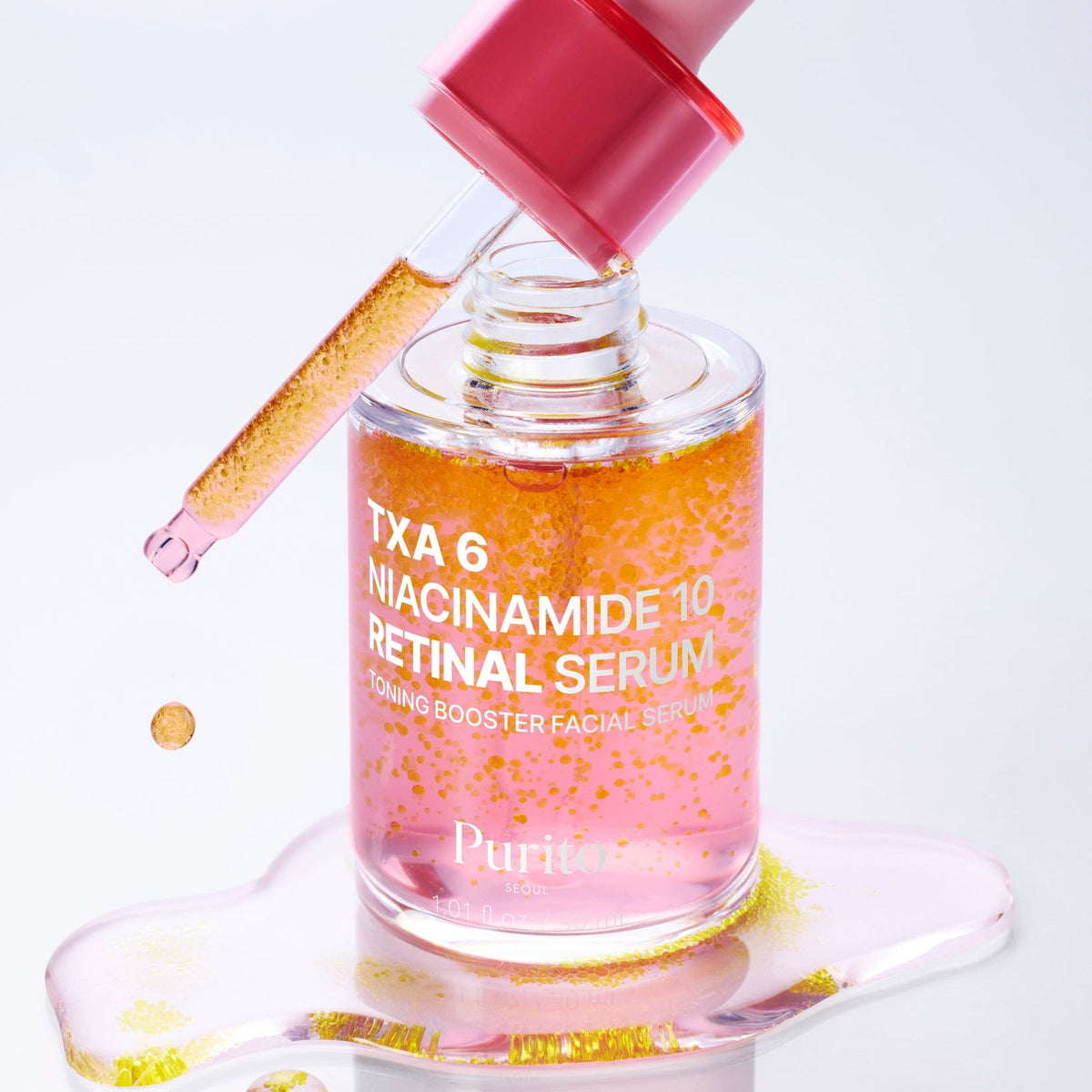 Flacon rose ouvert avec sa pipette et des particules jaunes dans le sérum