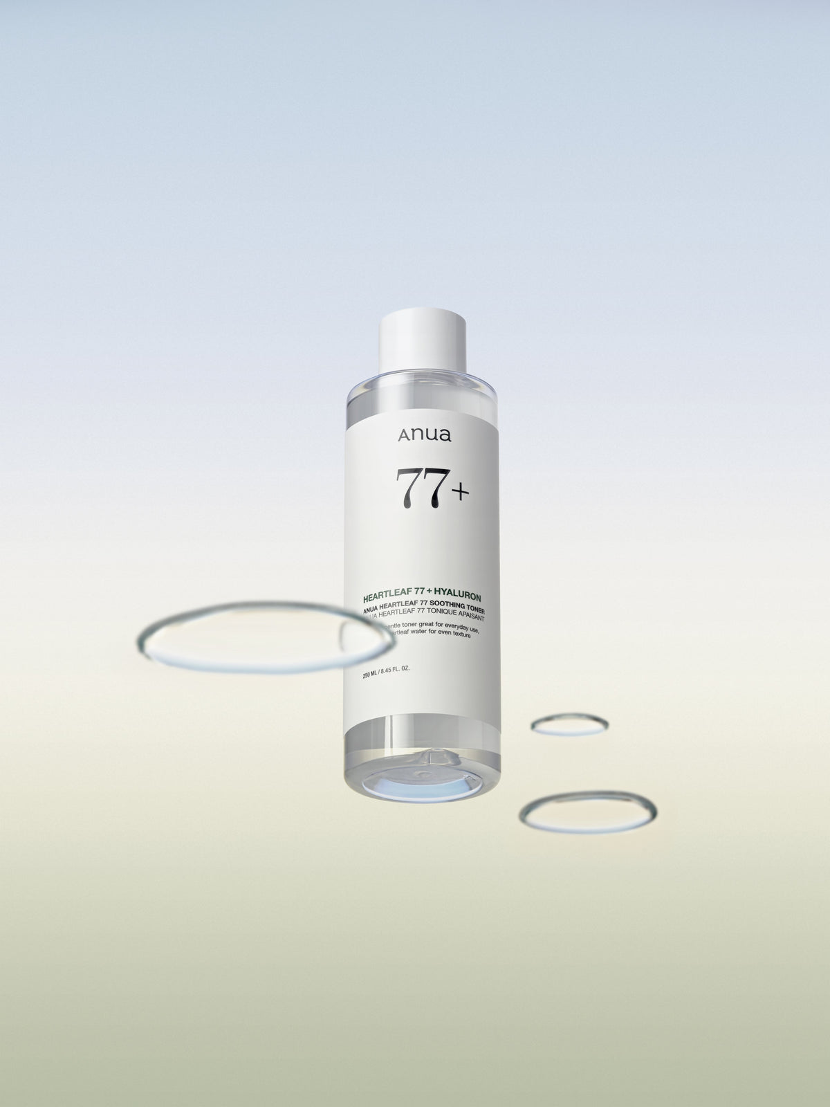 Flacon transparent de lotion entouré de gouttes d&