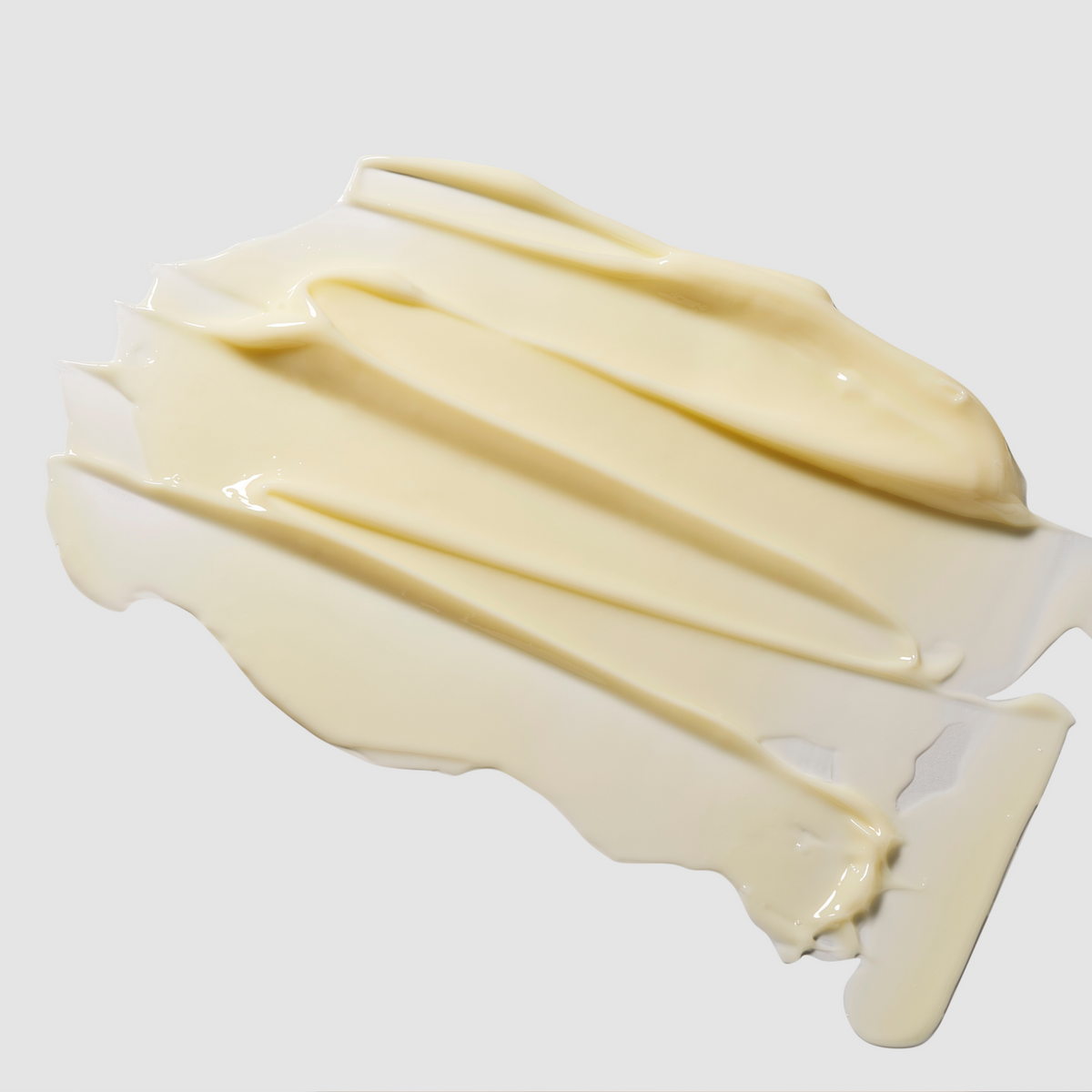 Texture de crème jaune pâle étalée en bandes