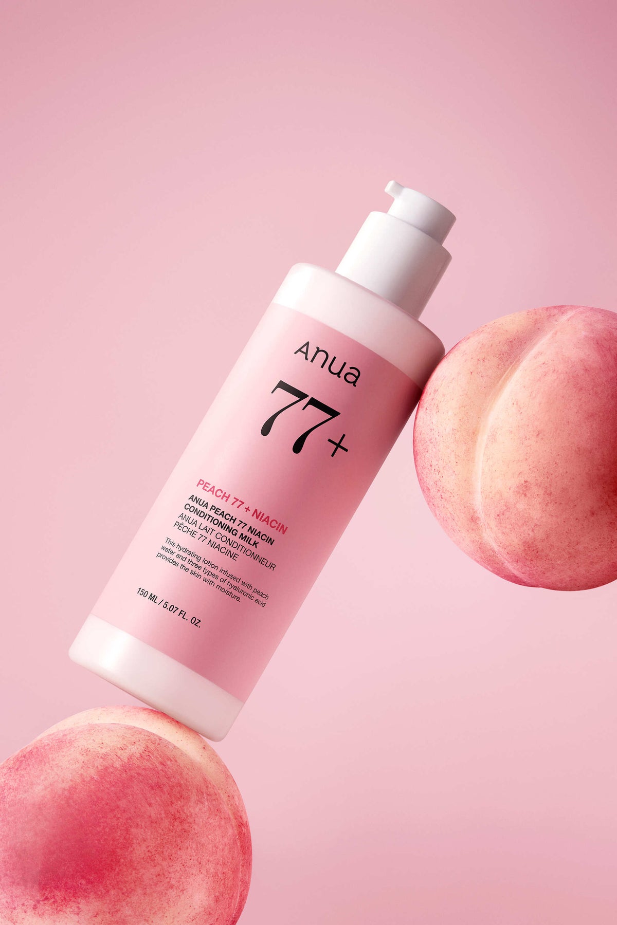 Flacon-pompe rose de 250 ml présenté entre des pêches