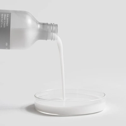 Lotion laiteuse versée dans une coupelle transparente