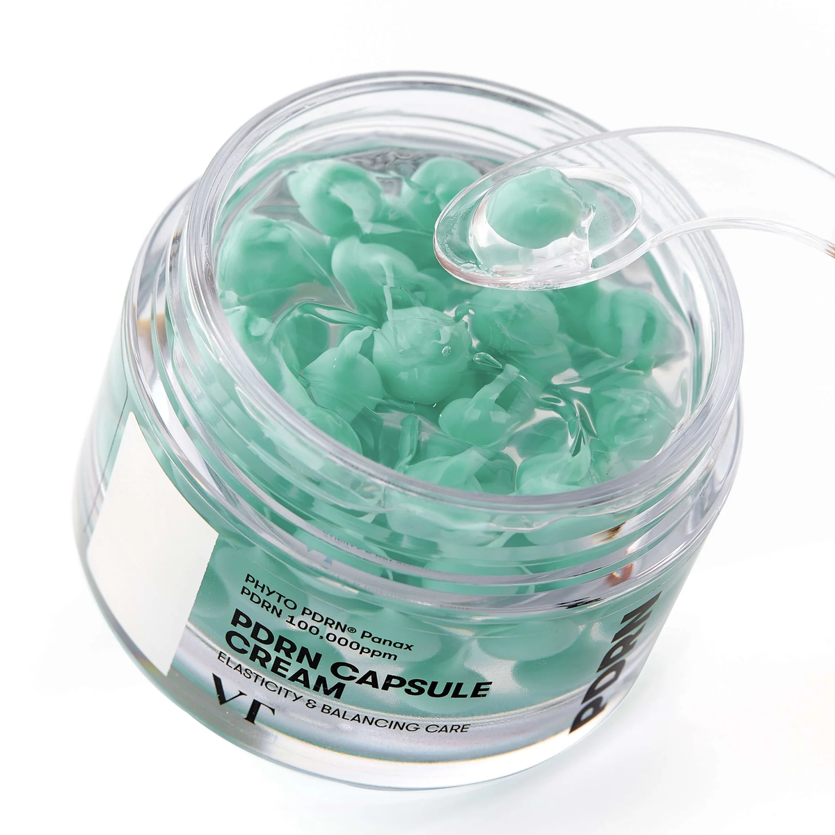 Capsule de crème verte prélevée à la spatule dans le pot ouvert